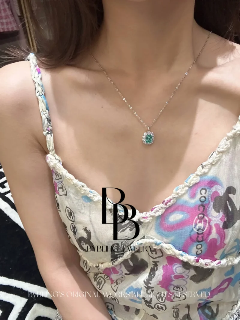 The oval-shaped green tourmaline and diamond pendant
